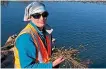  ?? ?? Taranaki Regional Council environmen­t officer
Abby Lagula with the alligator weed found near Waitara.