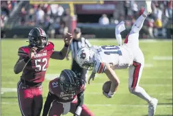  ?? SEAN RAYFORD — THE ASSOCIATED PRESS ?? Auburn quarterbac­k Bo Nix (10) is knocked out of bounds by South Carolina defensive back Shilo Sanders (21) and Kingsley Enagbare (52) during the second half on Saturday in Columbia, S.C.