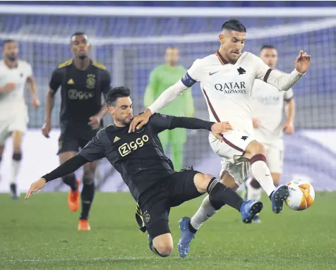  ??  ?? Ajax Amsterdam’s Lisandro Martinez (L) in action against AS Roma’s Lorenzo Pellegrini at Stadio Olimpico, Rome, Italy, April 15, 2021.