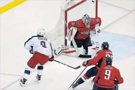  ?? COLUMBUS DISPATCH FILE PHOTO ?? Columbus Blue Jackets' Artemi Panarin scores the game-winning goal on Capitals goaltender Philipp Grubauer in overtime in Game 1 of their first-round series in Washington, D.C., last Thursday.