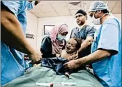  ?? RAAD ADAYLEH/AP ?? Staffers prepare Sara al-Matoura’s 1-year-old daughter, Eman, for surgery at a hospital in Amman, Jordan.