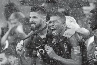  ?? NATACHA PISARENKO/AP PHOTO ?? France’s Kylian Mbappe, right, and Olivier Giroud celebrate following France’s 4-2 victory over Croatia in Sunday’s World Cup championsh­ip match in Moscow.