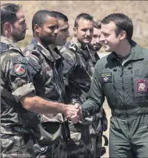  ?? (Photo AFP) ?? Le chef de l’Etat a endossé la tenue militaire et rendu de multiples hommages aux militaires.