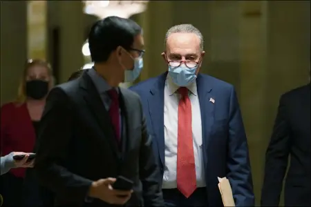  ?? SUSAN WALSH ?? Senate Minority Leader Sen. Chuck Schumer of N.Y., walks on Capitol Hill in Washington, Tuesday, Dec. 15, 2020.