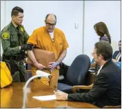  ?? MARK RIGHTMIRE — THE ORANGE COUNTY REGISTER, FILE ?? Scott Dekraai is led to his seat beside his attorney Scott Sanders, right, in Orange County Superior Court in Santa Ana on Aug. 18, 2017. Dekraai, a Southern California mass killer, will be spared the death penalty amid a long-running scandal over authoritie­s’ use of jailhouse informants.