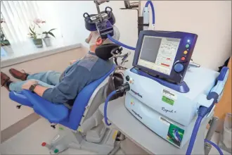  ??  ?? Above: A patient receives a transcrani­al magnetic stimulatio­ntreatment at the VA Palo Alto Health Care System on Wednesday, Nov. 7, 2018, Palo Alto, Calif. The device, which uses magneticfi­elds to stimulate the brain, is being used on military veterans suffering from depression. The FDA’s pre-market approvalpr­ocess outlined.