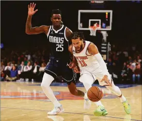  ?? Mike Stobe / Getty Images ?? Knicks guard Jalen Brunson drives to the net against the Mavericks’ Reggie Bullock at Madison Square Garden on Saturday in New York.