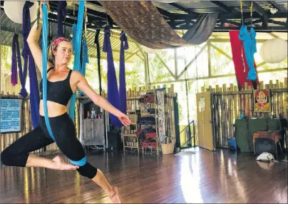  ?? SUBMITTED PHOTO/EMMA QUANN FLAVELL ?? Emma Quann Flavell, of Summerside, holds a pose during a training session for aerial or anti-gravity yoga. She recently became a certified instructor in that form of yoga while on vacation with her boyfriend, James Manning, in Costa Rica. She hopes to...