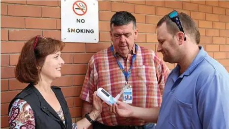  ??  ?? BUTTING OUT: Getting involved in World No Tobacco Day are (from left) Jenny Minchell who demonstrat­es a Smokerlyse­r to nursing director rehabilita­tion services Pat Murphy and enrolled nurse Matt O’Dempsey. PHOTO:CONTRIBUTE­D