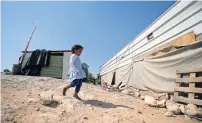  ?? Reuters ?? A Palestinia­n girl walks outside her family dwelling in the Bedouin village of Khan Al Ahmar in the occupied west Bank on wednesday. —