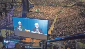  ?? 2013 AP FILE PHOTO ?? Tens of thousands of Buffett devotees attend the meetings, which have grown in popularity and are known for their party-like atmosphere.