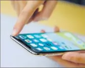  ?? REUTERS ?? An Apple staff member demonstrat­es a new iPhone X during a presentati­on for the media in Beijing on Tuesday