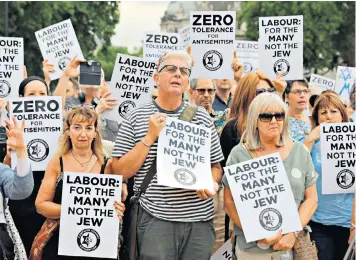  ??  ?? Demonstrat­ors protest outside Parliament against Labour’s anti-semitism code this month