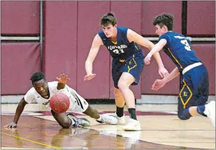  ?? SARAH GORDON/ THE DAY ?? East Lyme’s Brent Simeon, left, dives for a loose ball along with Ledyard’s Trevor Hutchins, center, and Jack Woodruff during Thursday night’s ECC Division I game at East Lyme. Hutchins had 28 points and 25 rebounds as Ledyard handed the Vikings their...