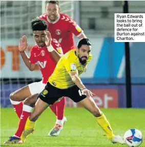  ??  ?? Ryan Edwards looks to bring the ball out of defence for Burton against Charlton.