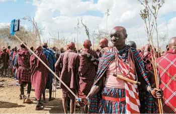  ?? AP ?? Rite of passage in Kenya: A Maasai warrior takes a selfie Wednesday at an Olng’esherr ceremony near Kajiado, Kenya. The ceremony, which attracted more than 10,000 Maasai from around the region, is a meat-eating rite of passage that takes place once every 15 years and marks the end of being a young warrior and the beginning of becoming an elder.
