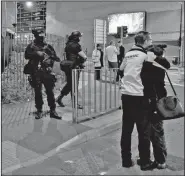  ?? AP/PETER BYRNE ?? Armed police stand guard Monday at Manchester Arena after an explosion during a concert in Manchester, England.