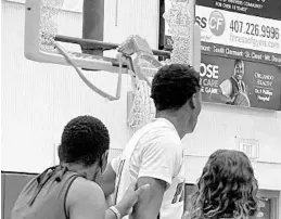  ?? ALAN DARTY ?? A shaken Dr. Phillips junior center Ernest Udeh Jr. looks at the damage done to a backboard when he attempted a putback dunk in a boys basketball region quarterfin­al home game against Oviedo on Thursday.