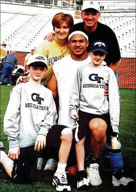  ?? CONTRIBUTE­D PHOTOS ?? Carter Martin (lower right) with dad Scott, Reggie Ball, mom Leigh Ann and brother Candler during a special day on the field at Bobby Dodd Stadium.