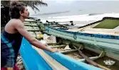  ??  ?? Aluthgama: A fisherman looks out at the rough sea