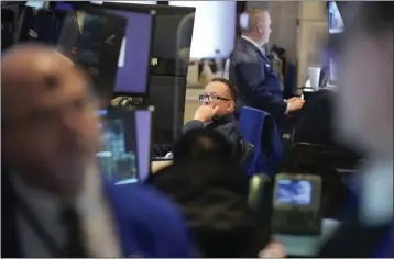  ?? SETH WENIG — THE ASSOCIATED PRESS ?? Traders work on the floor of the New York Stock Exchange in New York on Wednesday.