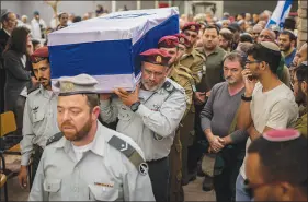  ?? OHAD ZWIGENBERG / ASSOCIATED PRESS ?? Israeli soldiers carry the flag-draped casket of Staff Sgt. Emanuel Feleke during his funeral Thursday at the Kiryat Gat’s military cemetery in Israel. Feleke was killed during a military ground operation in the Gaza Strip.