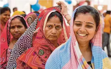  ?? AFP PIC ?? Voters queuing at a polling station in Rampur village in Allahabad, Uttar Pradesh, yesterday.