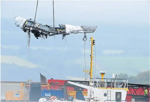  ??  ?? RETRIEVED FROM THE DEEP: Wreckage from one of the jets involved in the crash over the Moray Firth is winched ashore