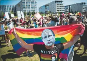  ?? Jonathan Nackstrand, AFP ?? A protester wears a mask featuring a portrait of Russian President Vladimir Putin during the “Helsinki against Trump and Putin” demonstrat­ion on Monday in Helsinki.