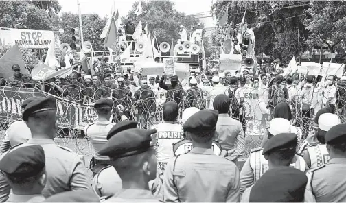  ?? — Gambar Reuters ?? PENUNJUK perasaan mengadakan rapat umum memprotes Myanmar di luar kedutaan Myanmar di Jakarta.