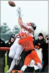  ??  ?? Brother Rice receiver Anthony Arquilla goes up to make a catch against Marist on Saturday.