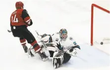  ?? Ross D. Franklin / Associated Press ?? The Coyotes’ Richard Panik (14) scores a short-handed goal against Sharks goalie Aaron Dell in the first period.