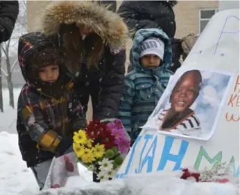  ??  ?? Adam Caponigro, 3, left, who attended daycare with Elijah, at the vigil with his mom, Maria, and brother Daniel, 5.