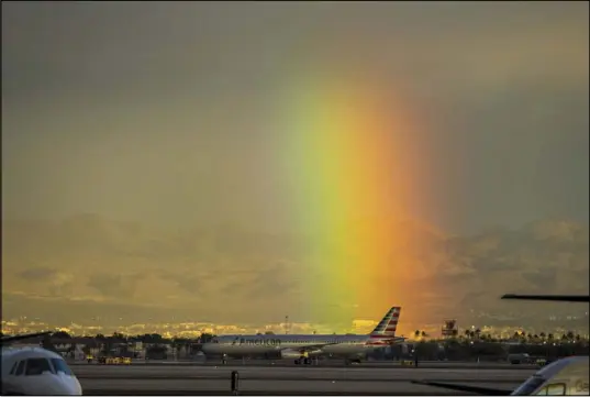  ?? L.E. Baskow Las Vegas Review-Journal @Left_Eye_Images ?? A rainbow shines bright Saturday behind McCarran Internatio­nal Airport as the region saw its first winterlike storm.