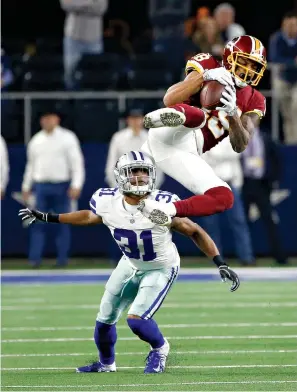  ?? AP Photo/Ron Jenkins ?? ■ Washington Redskins wide receiver Robert Davis (19) makes a catch over Dallas Cowboys cornerback Byron Jones (31) during the second half Thursday in Arlington, Texas.