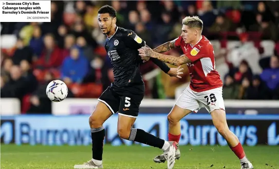  ?? ZAC GOODWIN/PA ?? Swansea City’s Ben Cabango tangles with Barnsley’s Dominik Frieser