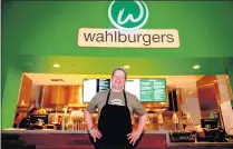  ??  ?? Paul Wahlberg, chef and cofounder of the Wahlburger­s restaurant chain, stands in front of the Morongo Casino, Resort and Spa location during an opening day promotiona­l event July 23.