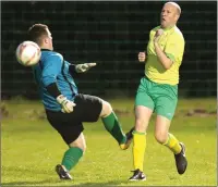  ??  ?? Colm Costigan of Torro gets to the ball just ahead of Albion goalkeeper Niall McDonnell but sees his shot hit the crossbar.