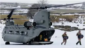  ??  ?? Welcome sight: An RAF Chinook arrives in rural Cumbria yesterday