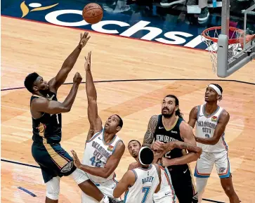  ??  ?? Steven Adams (12) looks on as New Orleans Pelicans forward Zion Williamson (1) shoots over Oklahoma City Thunder centre Al Horford (42) in the fourth quarter of an NBA basketball game in New Orleans yesterday. AP