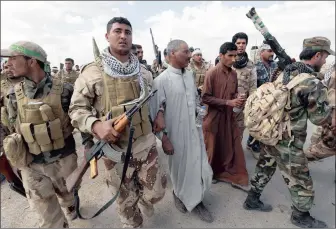  ?? Picture: REUTERS ?? Shia fighters detain men suspected of being linked to Islamic State in the town of Hamrin in Salahuddin, Iraq. Readers have expressed concern about extremists recruiting South Africans.