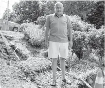  ??  ?? Adi Astl, 73, at the site of the stairs he built in June to help residents get down an embankment to reach Tom Riley Park in Toronto. His efforts and the city’s reaction have made Astl something of a celebrity.