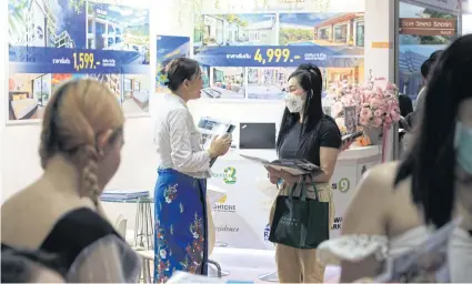  ?? APICHART JINAKUL ?? Hotel operators offer deals at the recent Thai Teaw Thai Fair. Mr Udom says labour costs account for 30-35% of hotel expenses.