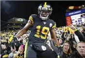  ?? DON WRIGHT — THE ASSOCIATED PRESS ?? Steelers receiver JuJu Smith-Schuster exits the stands Monday after celebratin­g his touchdown with fans.