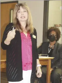  ?? Katie West • Times-Herald ?? Kristen Craig Garner, staff attorney for the Arkansas School Boards Associatio­n, speaks to members of the Forrest City School Board about what constitute­s a good school board member as board president Sandra Taylor listens to the presentati­on. Garner offered the board training during Thursday’s meeting.