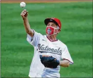  ?? ALEX BRANDON / AP ?? Dr. Anthony Fauci, director of the National Institute of Allergy and Infectious Diseases, threw out the first pitch on opening day before the New York Yankees and Washington Nationals played on July 23.