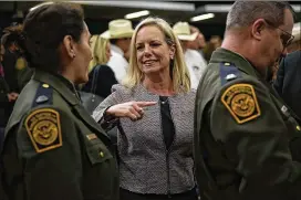  ?? PHOTOS BY ALEX WONG / GETTY IMAGES ?? Homeland Security Secretary Kirstjen Nielsen (center) greets U.S. Border Patrol members after an event Friday in Washington.