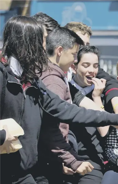  ??  ?? 0 First Minister Nicola Sturgeon shares her chips with schoolchil­dren on a campaign visit to