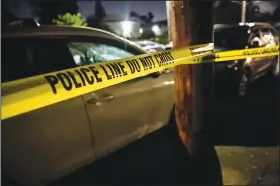  ?? (File Photo/The Oregonian/Mark Graves) ?? Portland police respond to a shooting June 6 in a house. The city’s police department is struggling to keep up with an increase in homicides amid an acute staffing shortage and budget cuts.