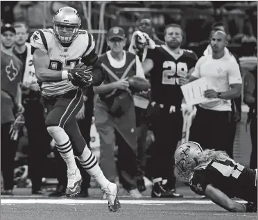  ?? BUTCH DILL/AP PHOTO ?? Patriots tight end Rob Gronkowski pulls in a touchdown reception in front of New Orleans linebacker Alex Anzalone during New England’s 36-20 win on Sunday in New Orleans.